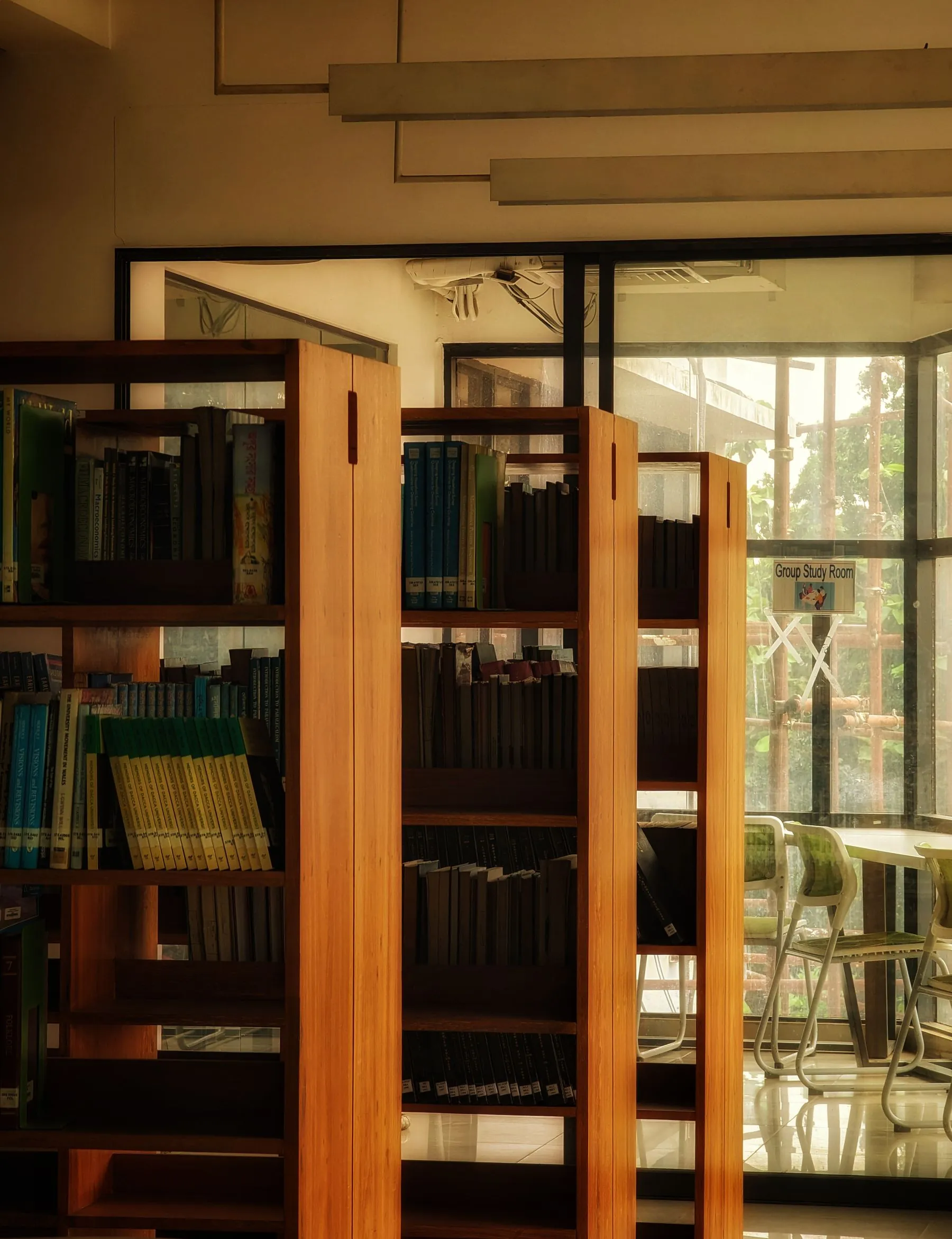 A warm library lined with wooden bookshelves