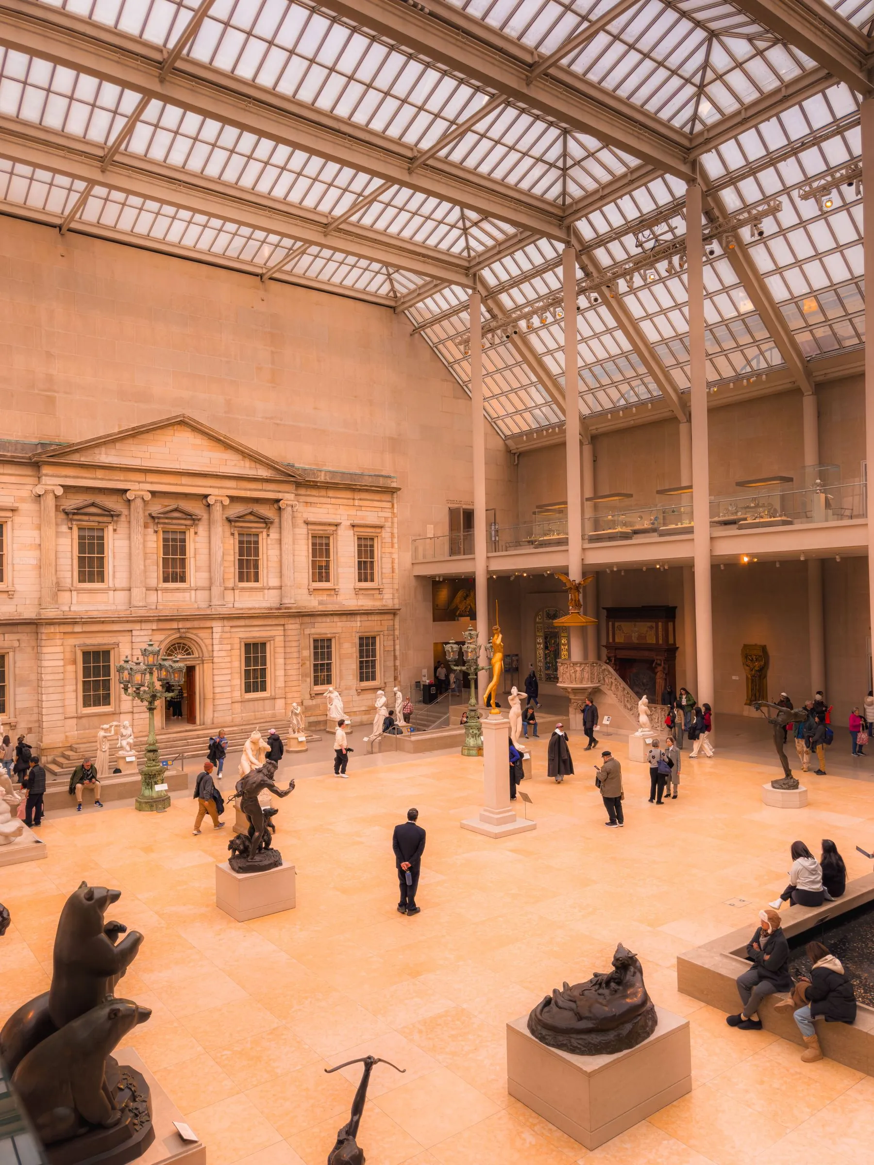 Visitors crossing a grand museum gallery
