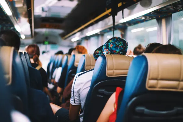 Passengers in soft focus aboard a bus