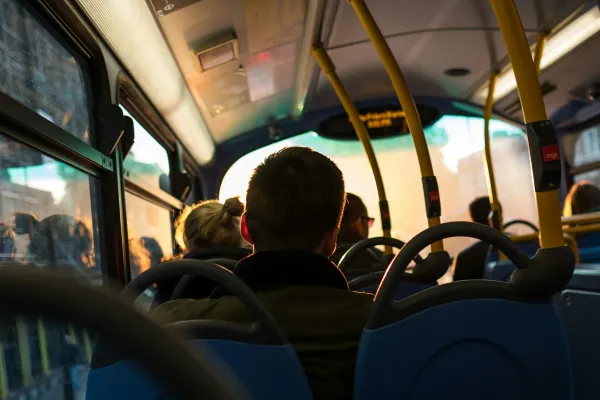 A passenger seated inside a public bus